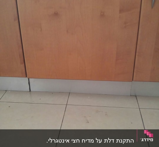 ארון עץ עם ידית מתכת ורצפת קרמיקה
